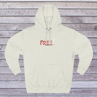 Oatmeal Heather Beige hoodie with red text on a wooden surface, 'I am free, Galatians'