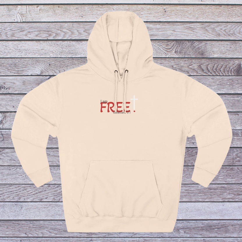 Pale Pink hoodie with 'FREE' printed on it against a wooden background