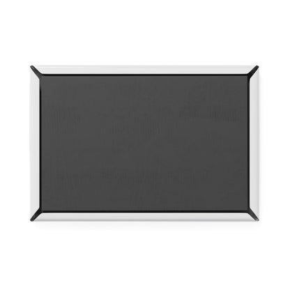 Black rectangular object with a silver border on a white background