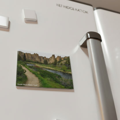 Fridge magnet of a scenic landscape on a refrigerator with other magnets.