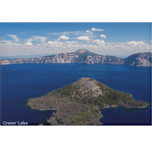 Crater Lake in Oregon with a small island covered in trees, surrounded by mountains.