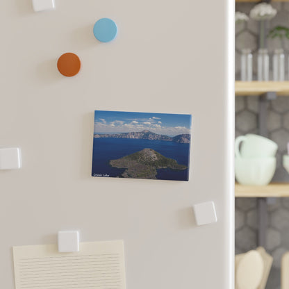 Canvas print of a mountain lake scene hanging on a wall with colorful hooks.