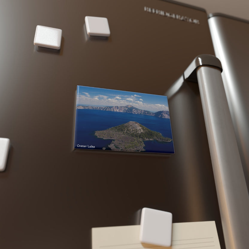 Magnet with a scenic view of a lake and mountains on a refrigerator door.
