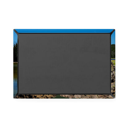 Black outdoor projector screen with blue border on a natural background