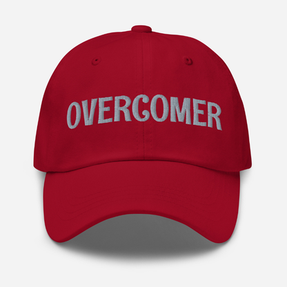 Cranberry Red cap with 'OVERCOMER' text on a white background