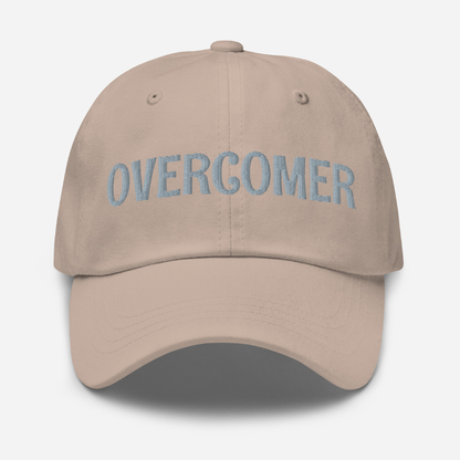 Stone Beige cap with 'OVERCOMER' embroidered on a white background