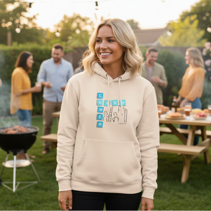 Sand Shell Beige hoodie with 'Overcomer, 1 John 5:4' graphic design at a BBQ with friends