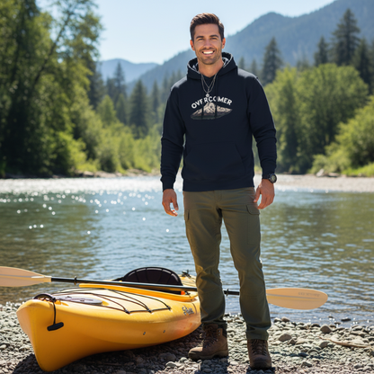 Navy blue hoodie with 'Overcomer' graphic over photo of Mt Hood in Oregon. Pictured by river and kayak.