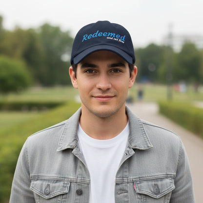 Navy blue cap with 'Redeemed and set free' text outside