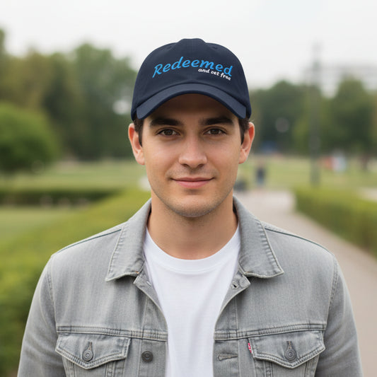 Navy blue cap with 'Redeemed and set free' text outside