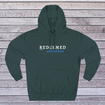 Green hoodie with 'REDEEMED and set free' text on a wooden background