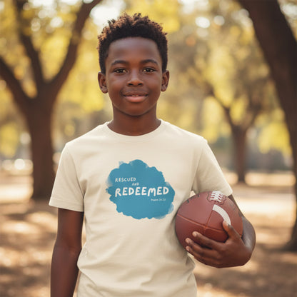 Natural colored t-shirt with blue graphic and text 'Rescued' and ' Redeemed' boy holding football