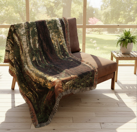 Woodland-themed blanket draped over a brown chair on porch
