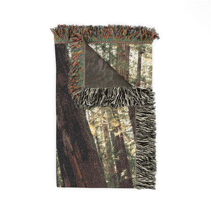Redwoods Trail blanket with fringes on a white background, folded