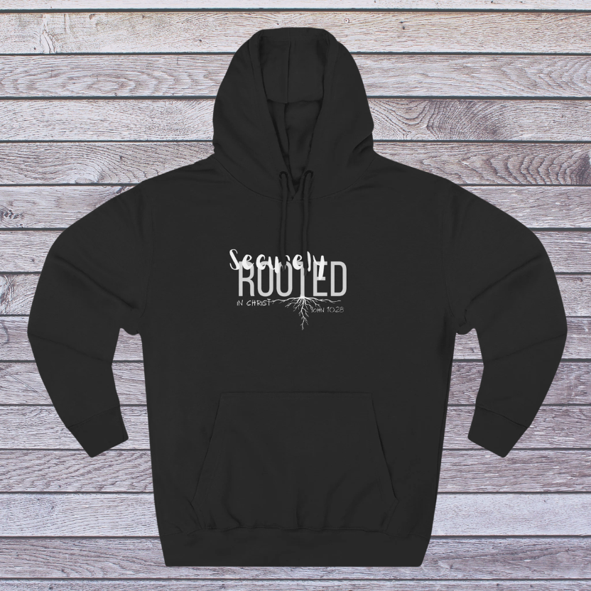 Black hoodie with white text 'Securely Rooted' on a wooden background