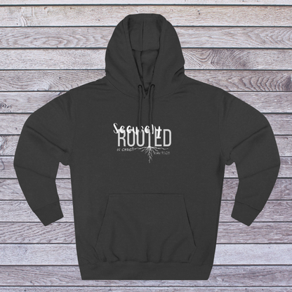 Charcoal heather hoodie with white text 'Securely Rooted' on a wooden background