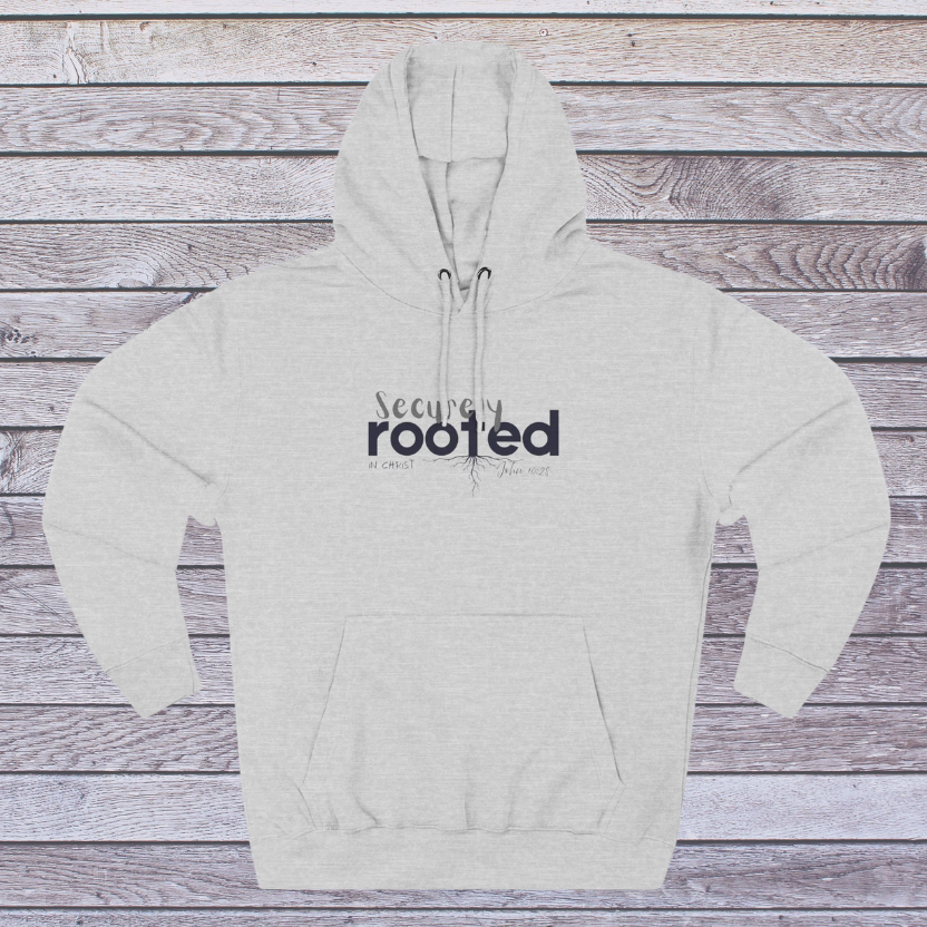 Gray hoodie with 'Securely Rooted' text on a wooden background