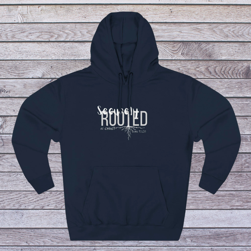 Navy blue hoodie with white text 'Securely Rooted' on a wooden background