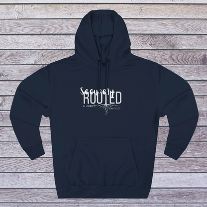 Navy blue hoodie with white text 'Securely Rooted' on a wooden background