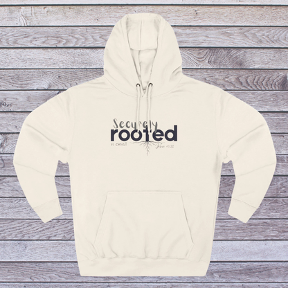 Sand Shell Beige hoodie with 'Securely Rooted' text on a wooden background