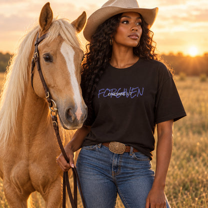 Person wearing a brown t-shirt with blue text 'forgiven'