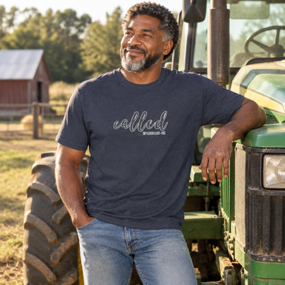 Man wearing a navy blue t-shirt with a logo, sitting on a tractor