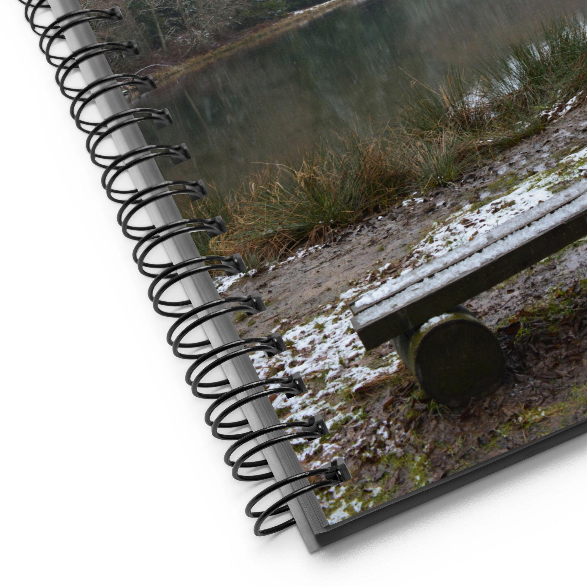 Spiral-bound notebook with a nature-themed cover showing a bench and grass.