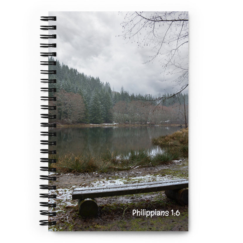 Notebook with a scenic cover featuring a lake and trees in Washington, and 'Philippians 1:6' printed on it.