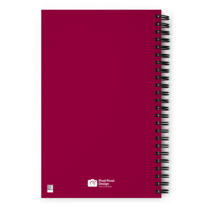 Red notebook with black spiral binding on a white background