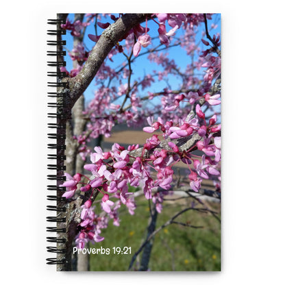 Notebook with a Kentucky pink flowering tree design and 'Proverbs 19:21' text on a white background