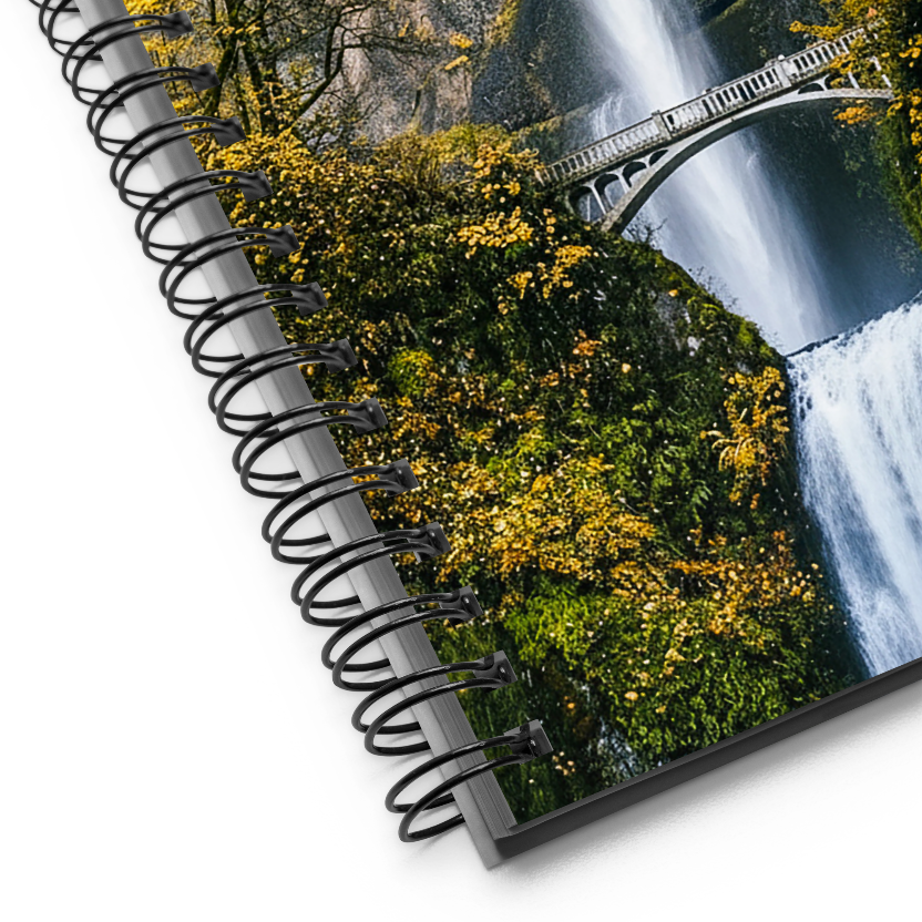 Spiral-bound notebook with a scenic cover featuring a waterfall and greenery