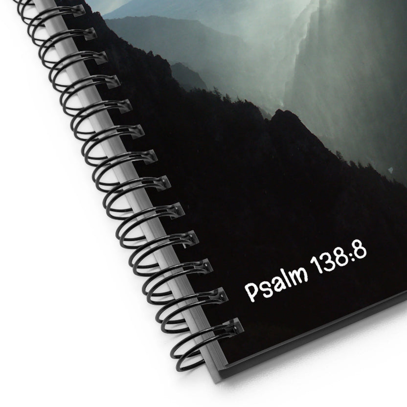 Black notebook with 'Psalm 138.8' text and mountainous landscape on cover