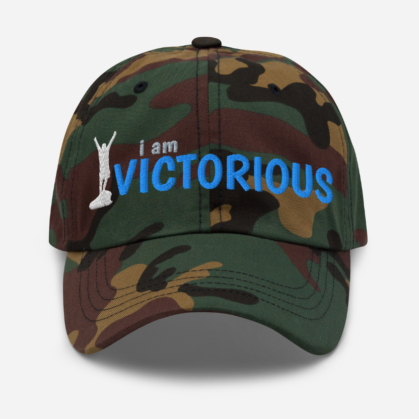 Camouflage cap with 'i am VICTORIOUS' text on a white background