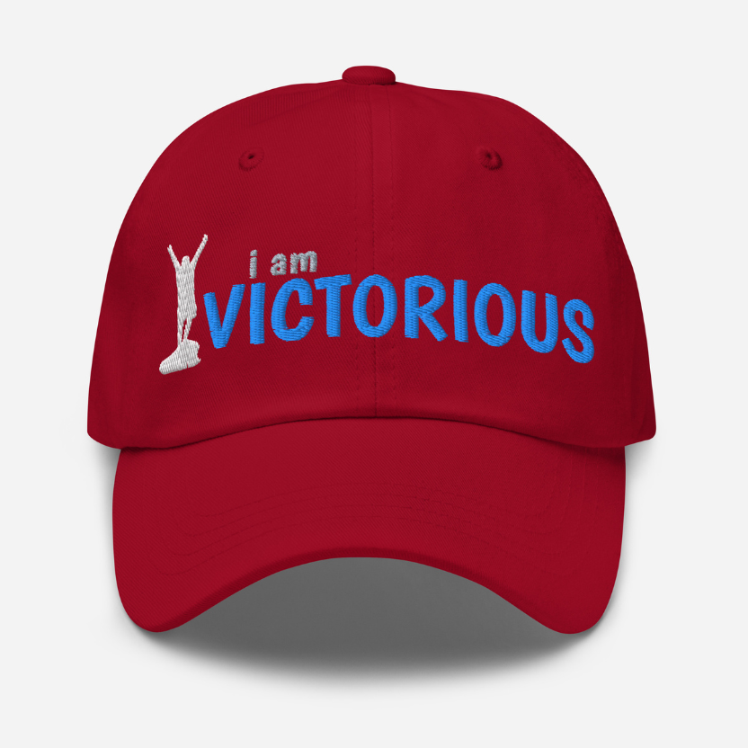 Red cranberry cap with 'i am VICTORIOUS' text and graphic on a white background