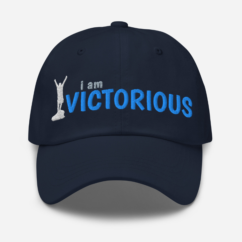 Navy blue cap with 'i am VICTORIOUS' text and silhouette on a white background