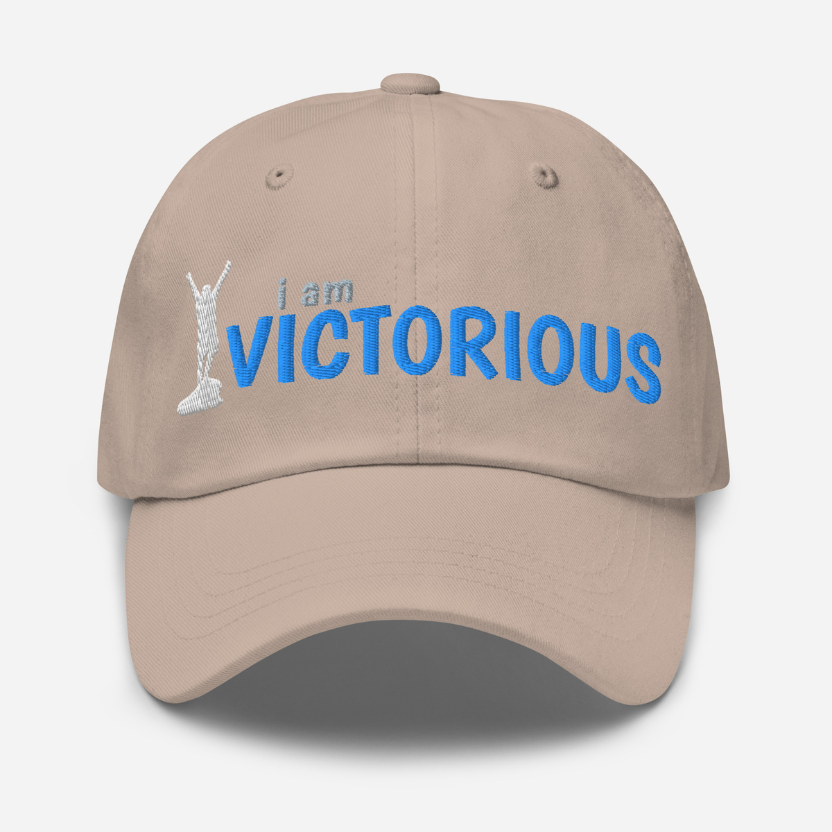 Beige cap with 'i am VICTORIOUS' text and graphic on a white background