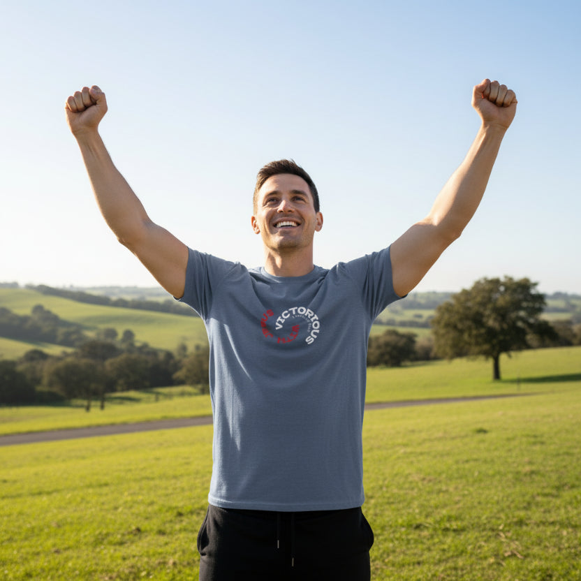 Blue Indigo t-shirt with 'Victorious with Jesus' circular original design, standing in victory. 