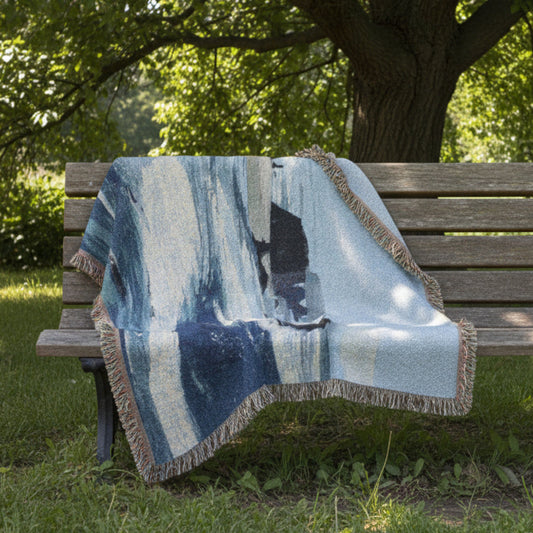 West Coast decorative woven blanket with nature design draped over a bench