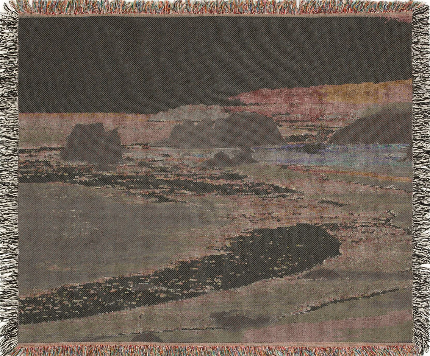 West Coast woven blanket with a landscape design of a beach and cliffs, backview.