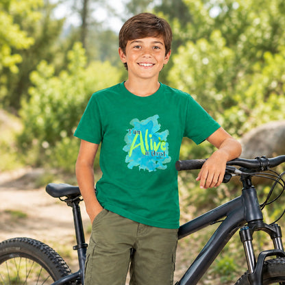 young boy with bike wearing green tee with design "I am Alive in Christ"