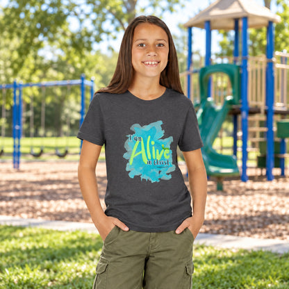 Girl wearing a gray t-shirt with a colorful graphic of Alive
