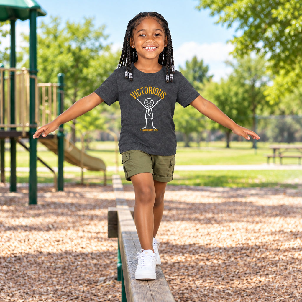 Girl wearing a gray t-shirt with a graphic design of a figure holding up the word "victorious"